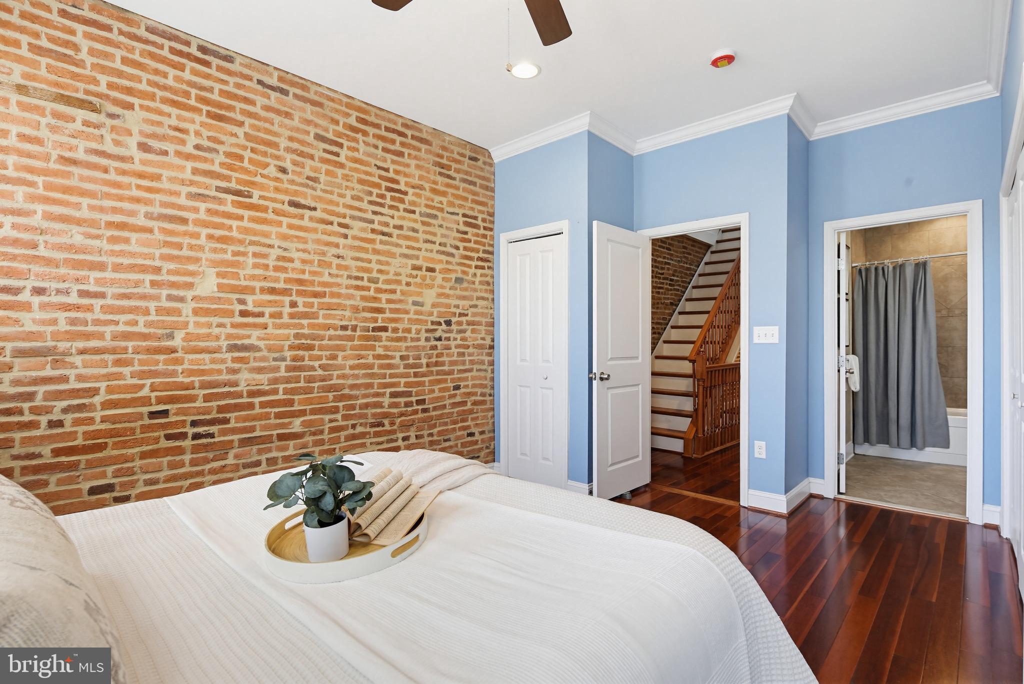 122 West Clement Street Baltimore, MD 21230 - Photo 16 of 40 a bedroom with a bed and a chair