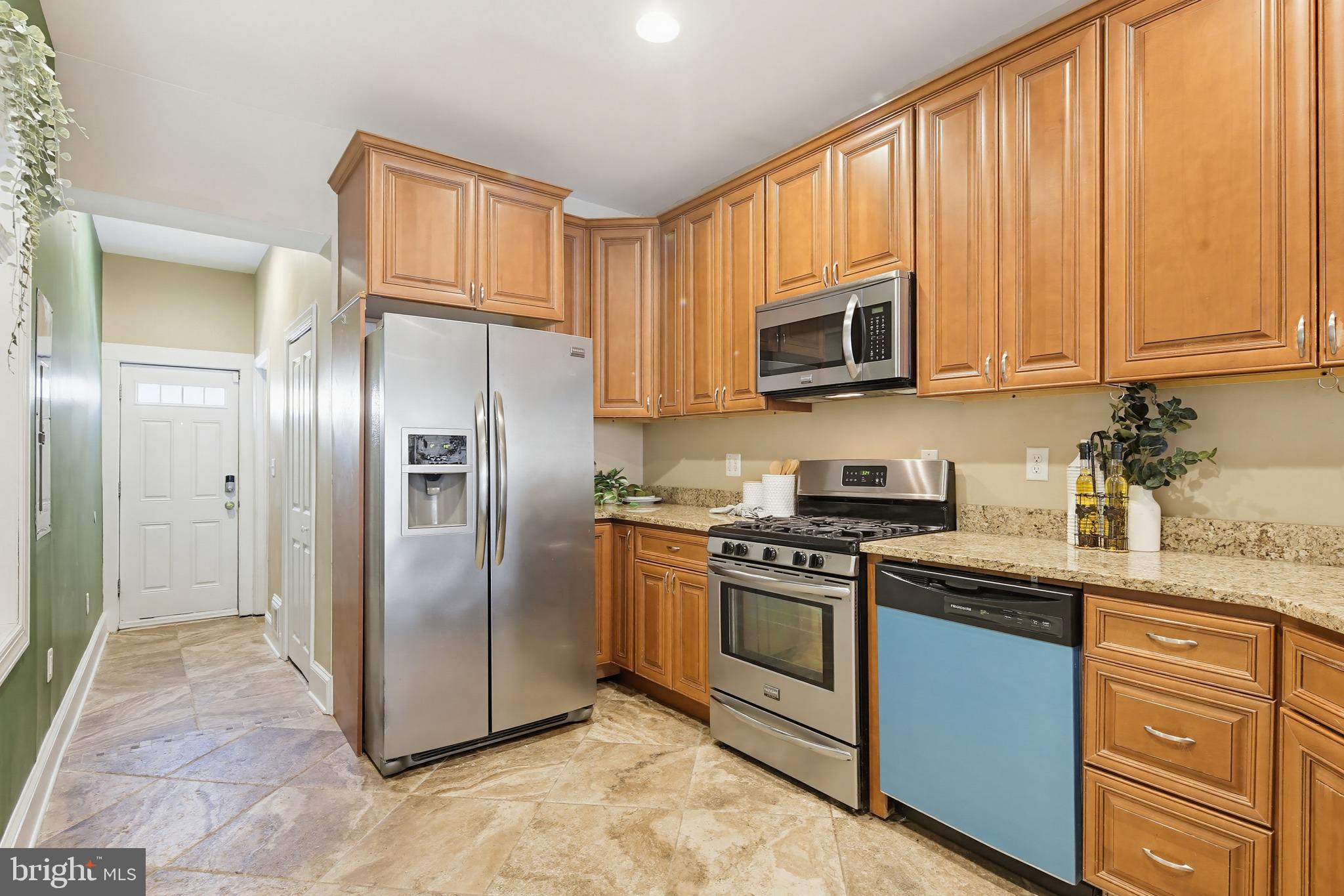 122 West Clement Street Baltimore, MD 21230 - Photo 5 of 40 a kitchen with stainless steel appliances granite countertop a refrigerator stove top oven and sink
