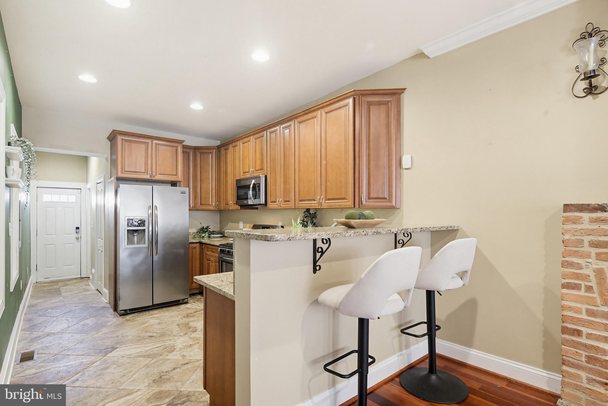 122 West Clement Street Baltimore, MD 21230 - Photo 9 of 40 a kitchen with stainless steel appliances granite countertop a refrigerator and a stove top oven
