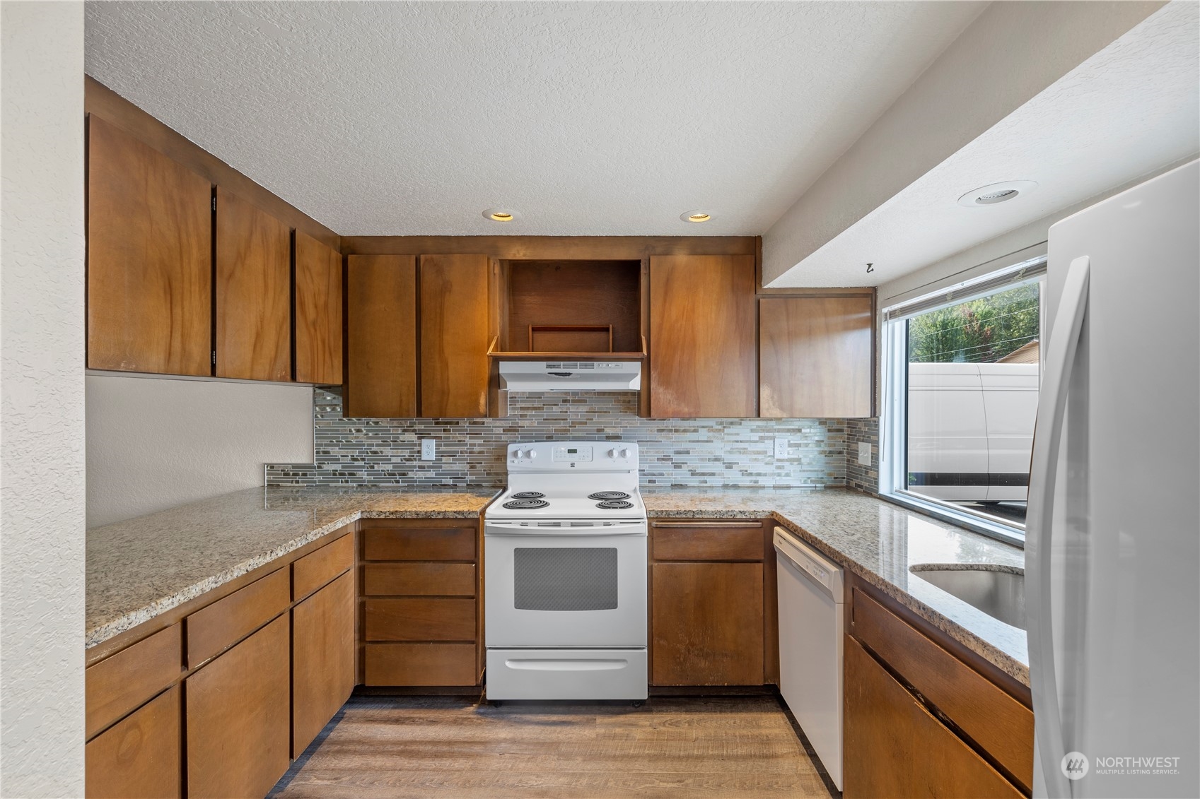 120 124th Street Southwest, Unit F2 Everett, WA 98204 - Photo 4 of 19 a kitchen with stainless steel appliances granite countertop a stove and a sink