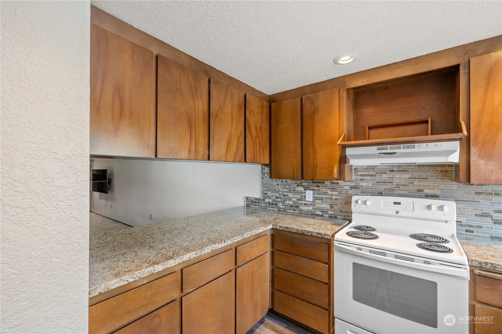 120 124th Street Southwest, Unit F2 Everett, WA 98204 - Photo 5 of 19 a kitchen with granite countertop cabinets stainless steel appliances and a counter space