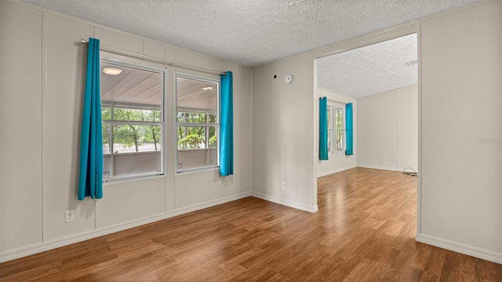 10379 Southwest 135 Street Archer, FL 32618 - Photo 11 of 45 a view of an empty room with wooden floor and a window