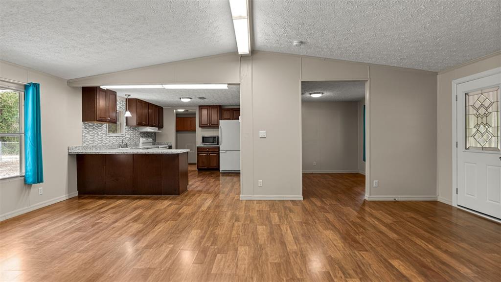 10379 Southwest 135 Street Archer, FL 32618 - Photo 13 of 45 a view of kitchen and kitchen with wooden floor