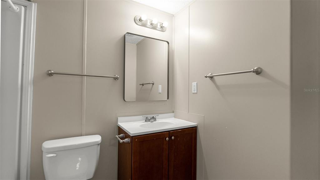 10379 Southwest 135 Street Archer, FL 32618 - Photo 21 of 45 a bathroom with a toilet sink and mirror