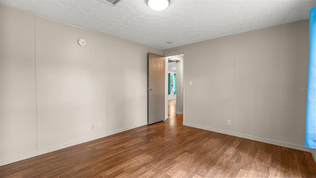 10379 Southwest 135 Street Archer, FL 32618 - Photo 23 of 45 a view of an empty room with wooden floor
