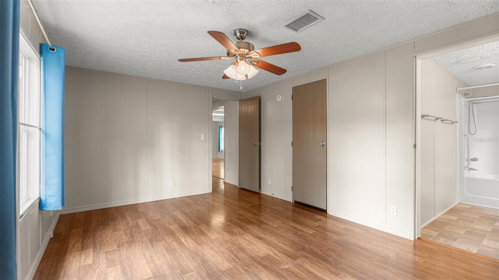 10379 Southwest 135 Street Archer, FL 32618 - Photo 26 of 45 a view of a livingroom with a ceiling fan and wooden floor