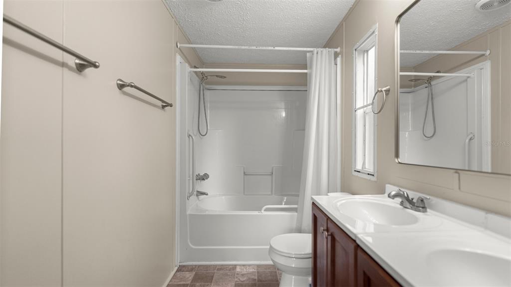 10379 Southwest 135 Street Archer, FL 32618 - Photo 27 of 45 a bathroom with a granite countertop sink toilet and shower
