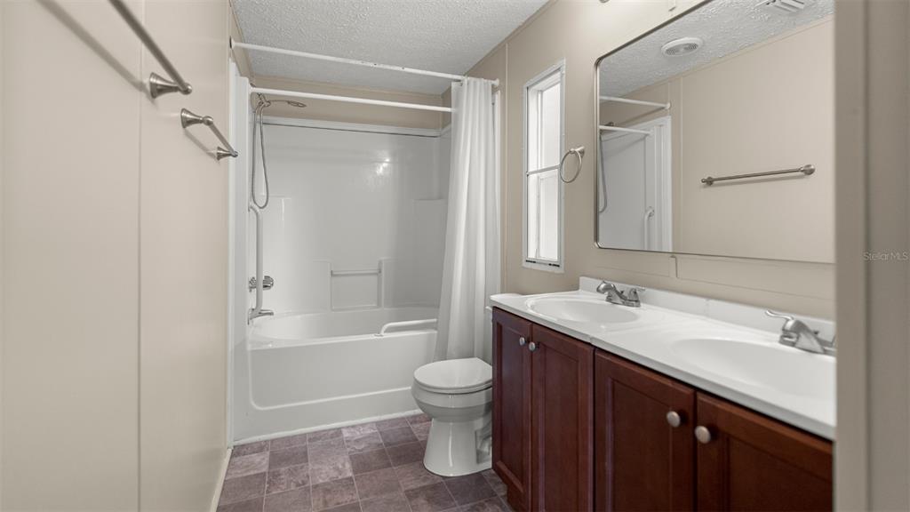 10379 Southwest 135 Street Archer, FL 32618 - Photo 28 of 45 a bathroom with a sink a toilet and shower