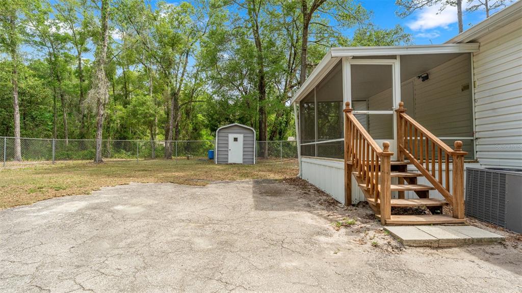 10379 Southwest 135 Street Archer, FL 32618 - Photo 31 of 45 a view of a house with backyard and deck