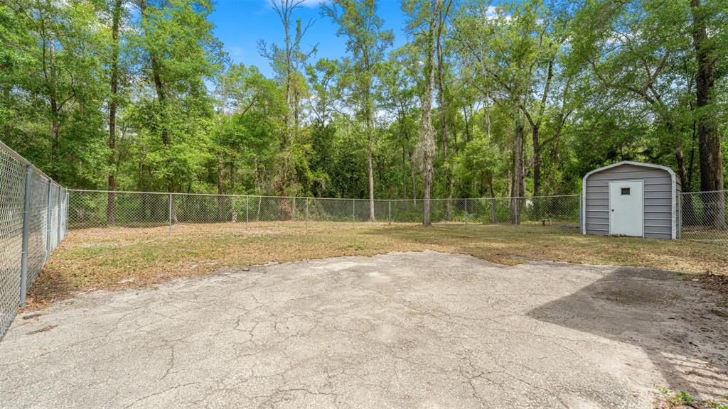 10379 Southwest 135 Street Archer, FL 32618 - Photo 32 of 45 a backyard of a house with lots of green space