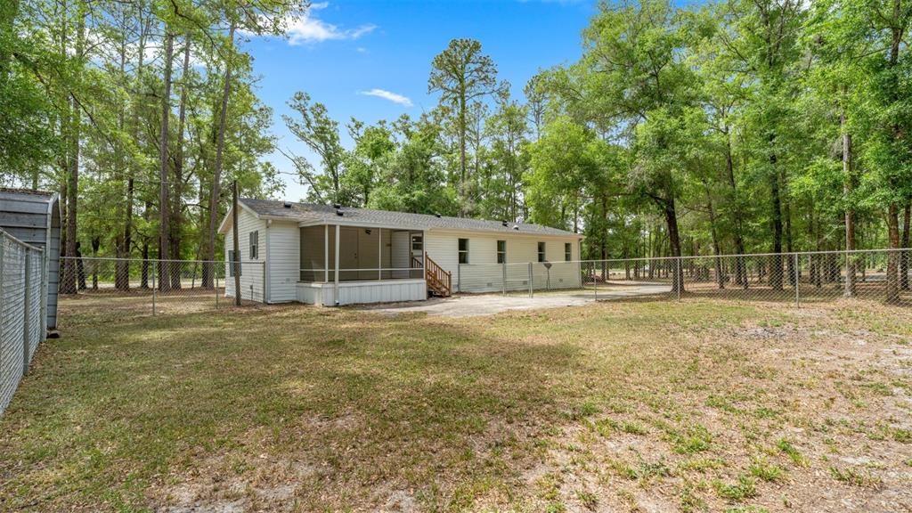 10379 Southwest 135 Street Archer, FL 32618 - Photo 33 of 45 a view of a house with backyard and trees