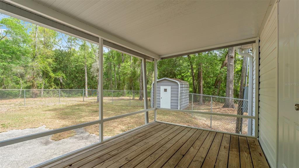 10379 Southwest 135 Street Archer, FL 32618 - Photo 35 of 45 a view of a room with wooden floor and a large window