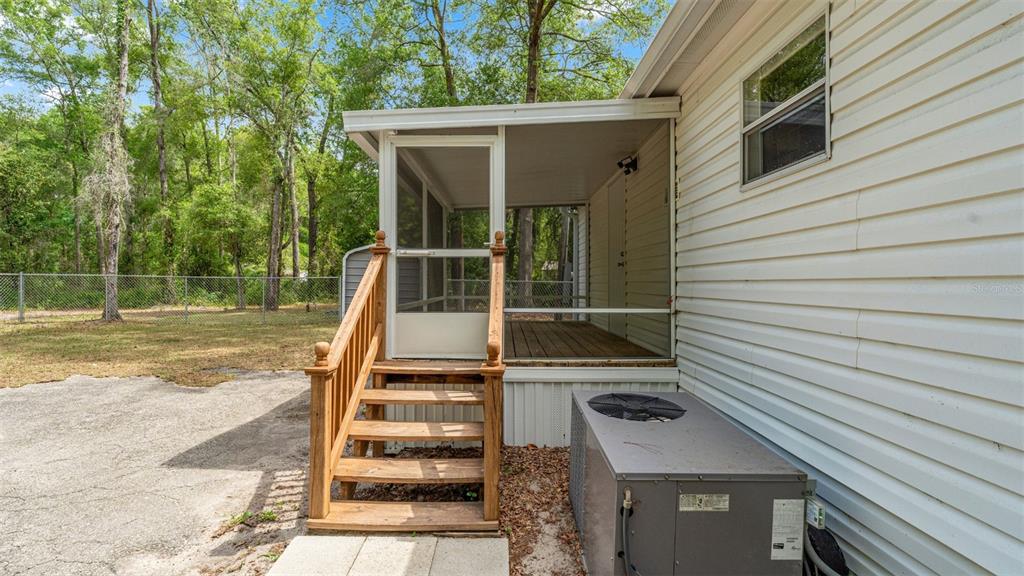 10379 Southwest 135 Street Archer, FL 32618 - Photo 36 of 45 a view of a balcony with wooden floor and fence