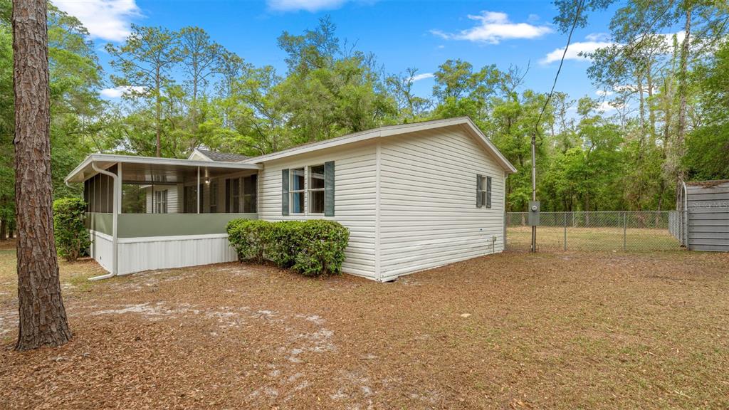 10379 Southwest 135 Street Archer, FL 32618 - Photo 41 of 45 a view of a house with a yard and potted plants