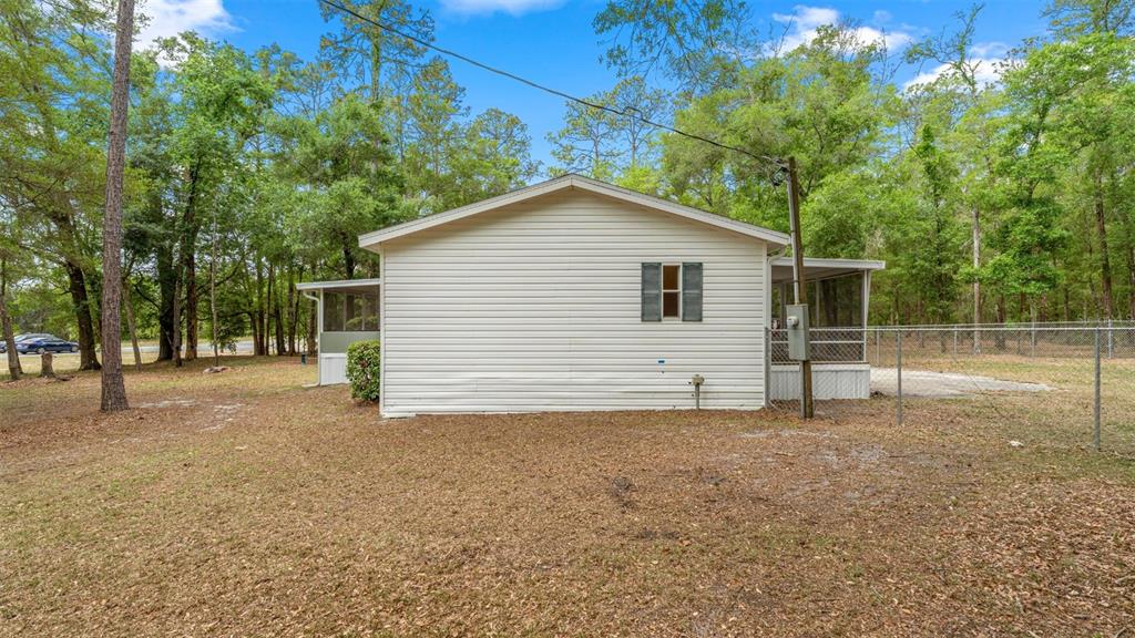 10379 Southwest 135 Street Archer, FL 32618 - Photo 42 of 45 a view of a house with a backyard
