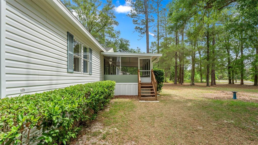 10379 Southwest 135 Street Archer, FL 32618 - Photo 43 of 45 a view of a house with backyard and a tree