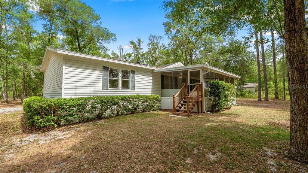 10379 Southwest 135 Street Archer, FL 32618 - Photo 44 of 45 a view of a house with backyard and garden