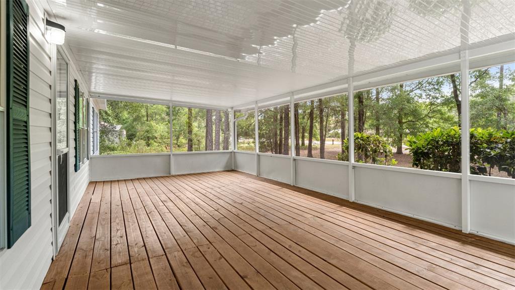 10379 Southwest 135 Street Archer, FL 32618 - Photo 5 of 45 a view of an empty room with wooden floor and a window