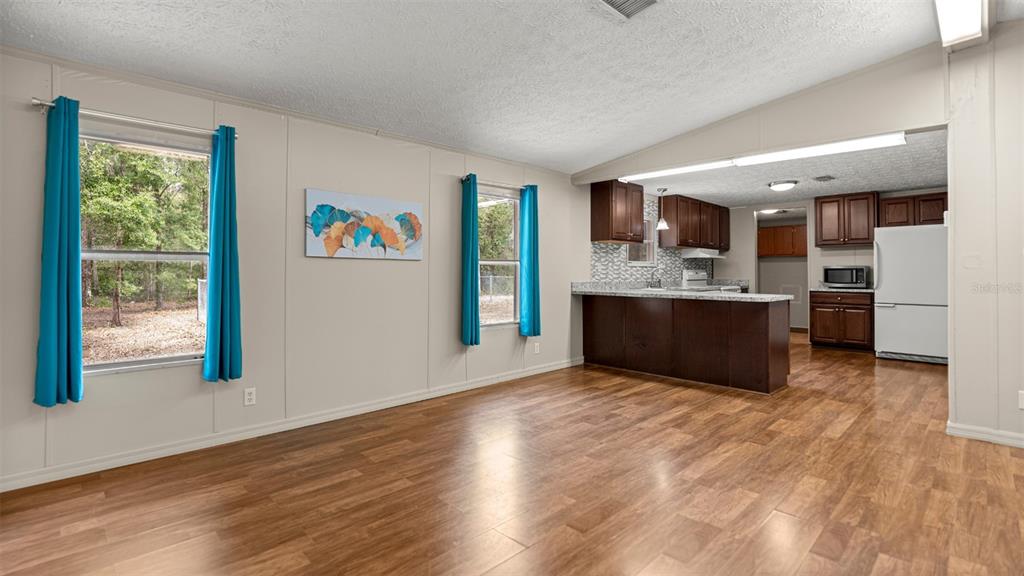 10379 Southwest 135 Street Archer, FL 32618 - Photo 7 of 45 a view of kitchen and window with wooden floor