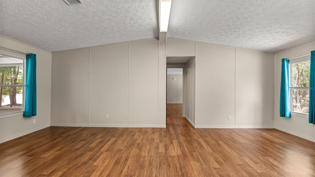 10379 Southwest 135 Street Archer, FL 32618 - Photo 10 of 45 a view of empty room with wooden floor and fan