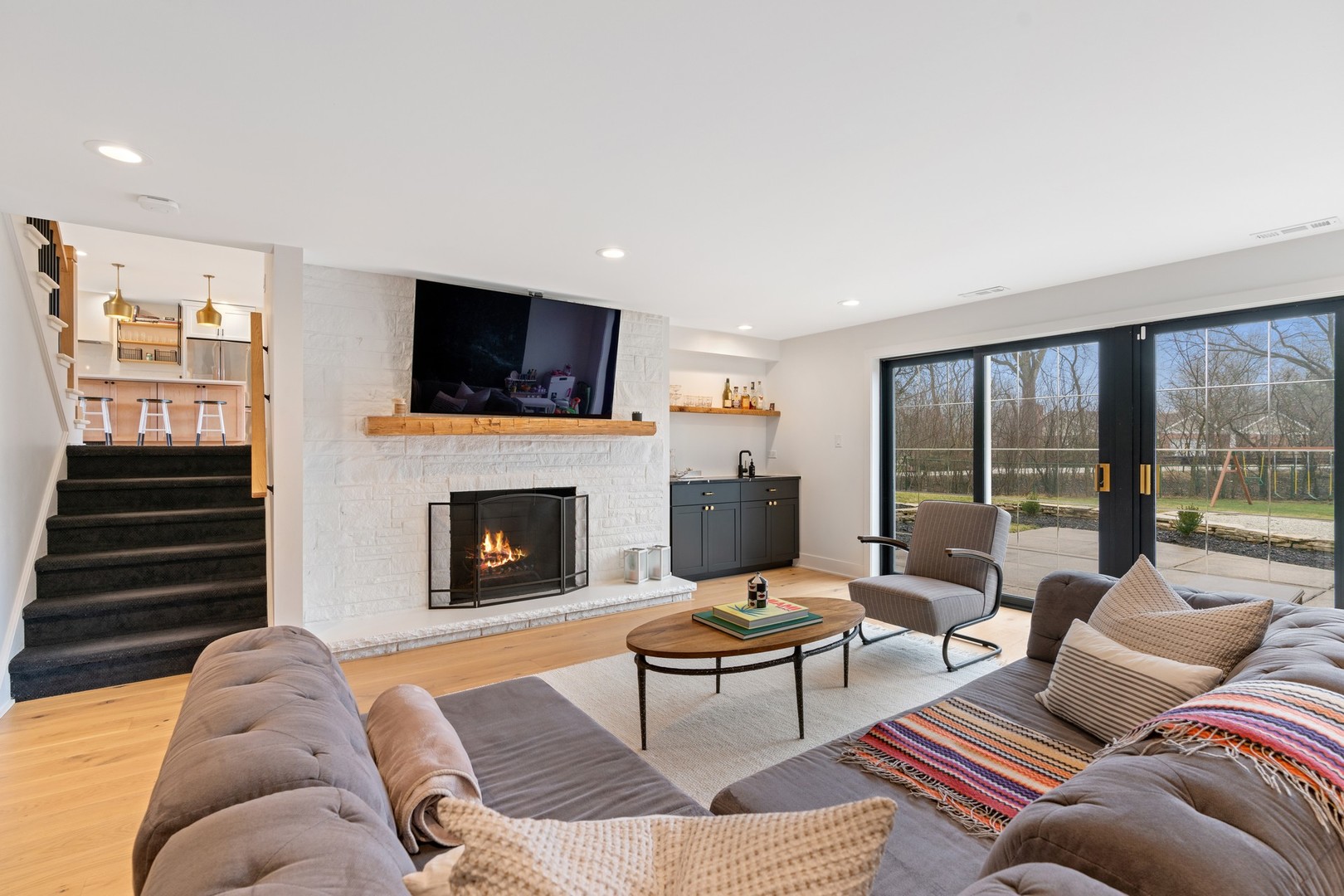 1975 Valley View Road Northfield, IL 60093 - Photo 17 of 40 a living room with furniture a flat screen tv and a fireplace