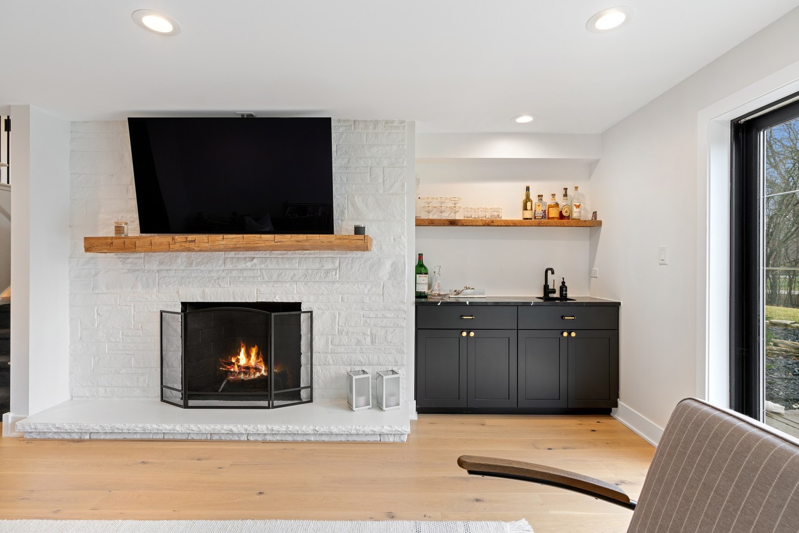 1975 Valley View Road Northfield, IL 60093 - Photo 19 of 40 a living room with stainless steel appliances furniture a fireplace and a flat screen tv