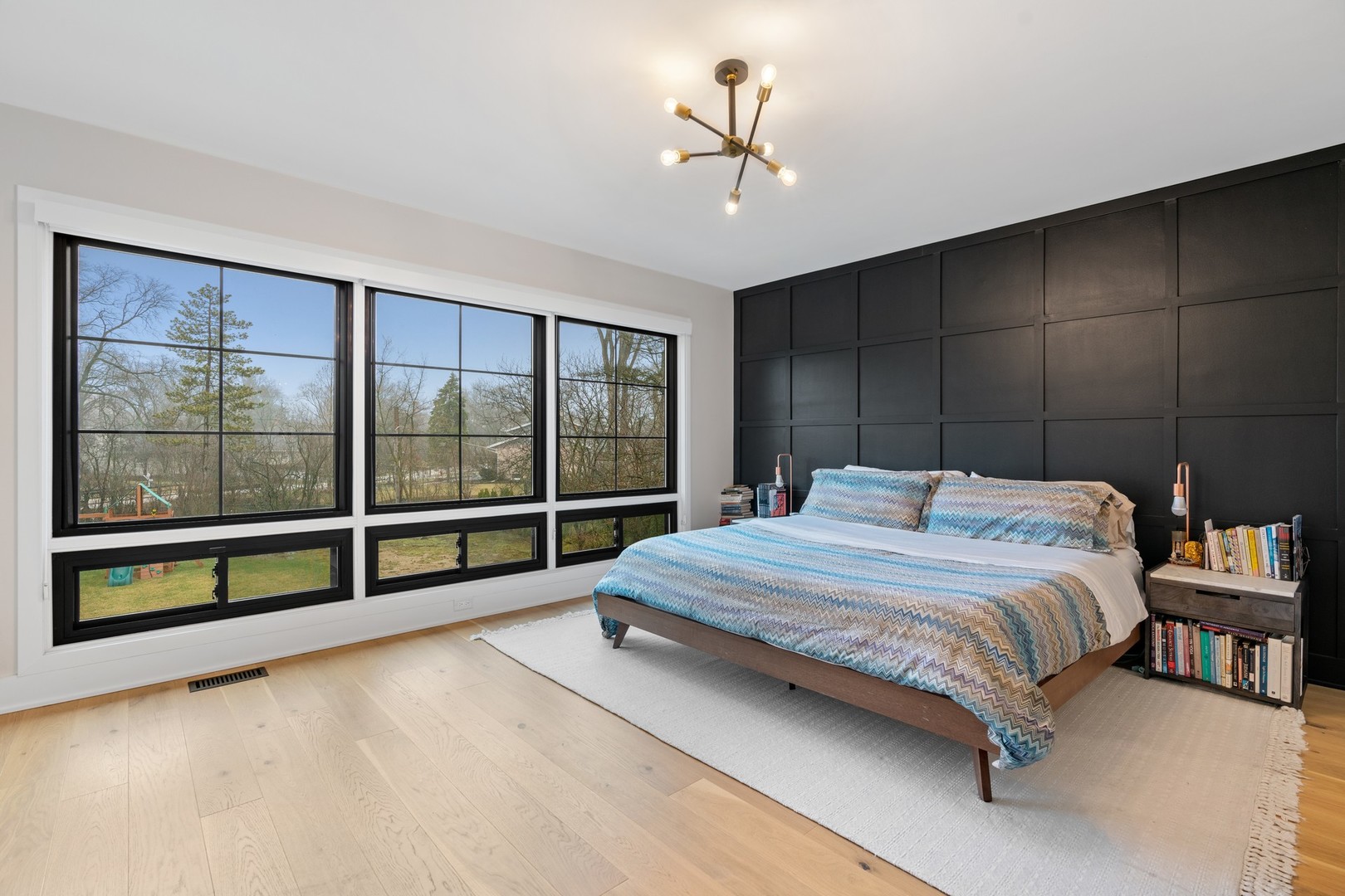 1975 Valley View Road Northfield, IL 60093 - Photo 20 of 40 a bedroom with a large bed and a chandelier fan