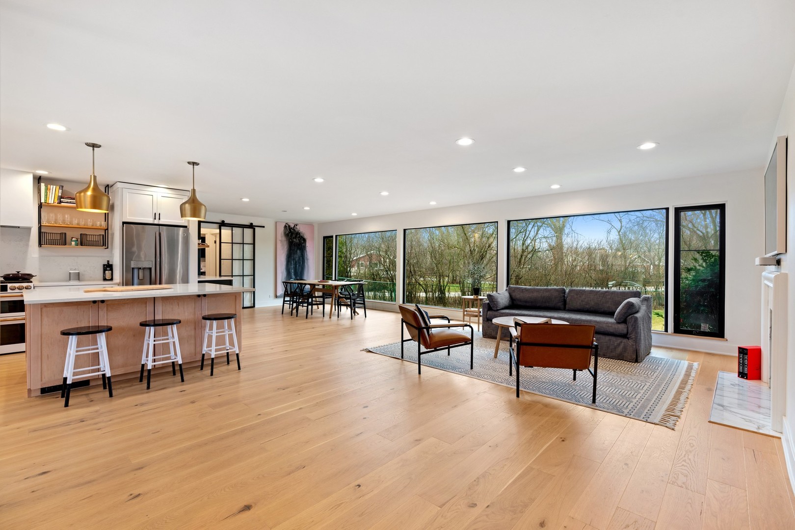 1975 Valley View Road Northfield, IL 60093 - Photo 2 of 40 a living room with furniture a flat screen tv and a floor to ceiling window