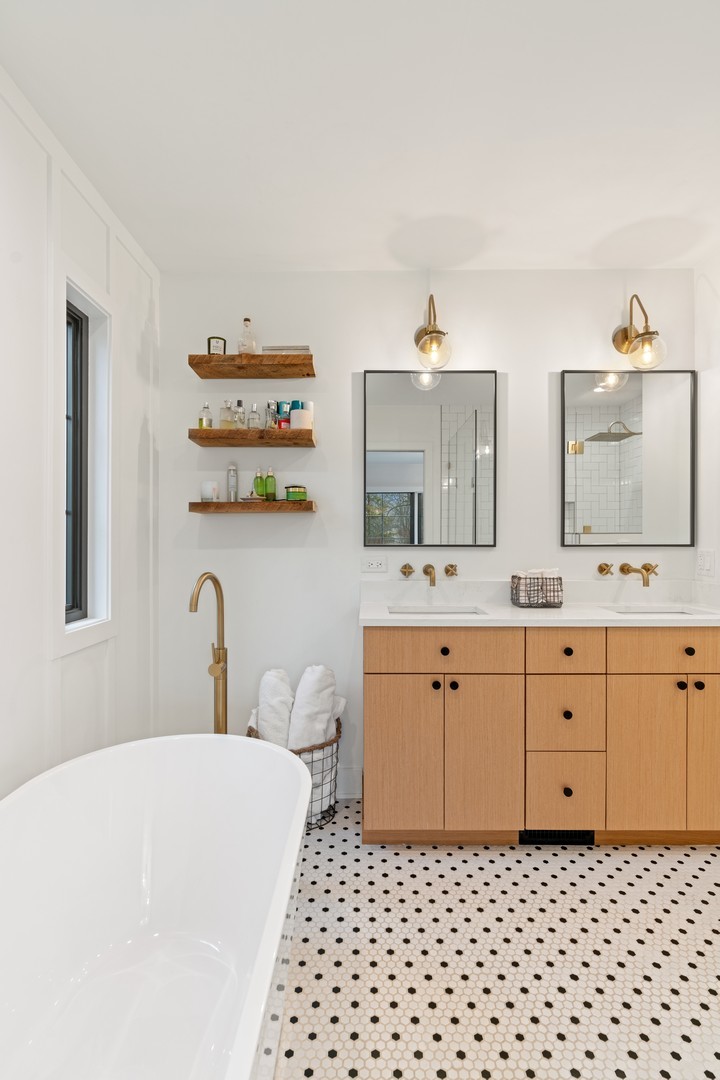 1975 Valley View Road Northfield, IL 60093 - Photo 23 of 40 a spacious bathroom with a double vanity sink mirror and toilet