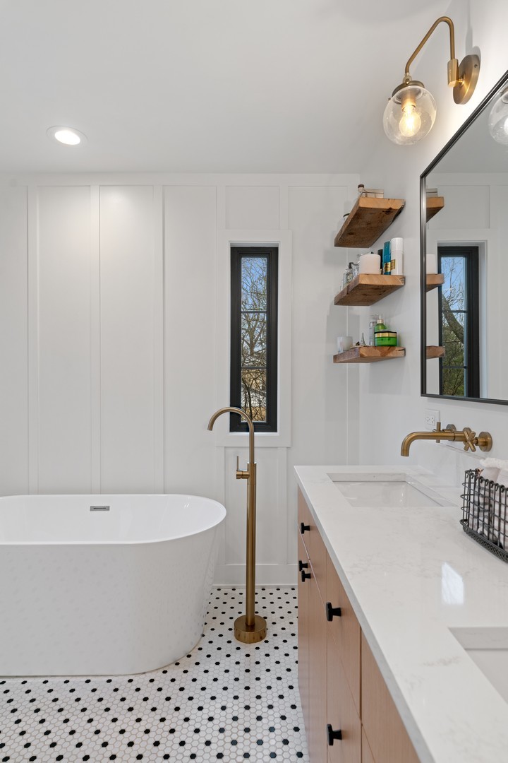 1975 Valley View Road Northfield, IL 60093 - Photo 24 of 40 a bathroom with a bathtub a sink and a window