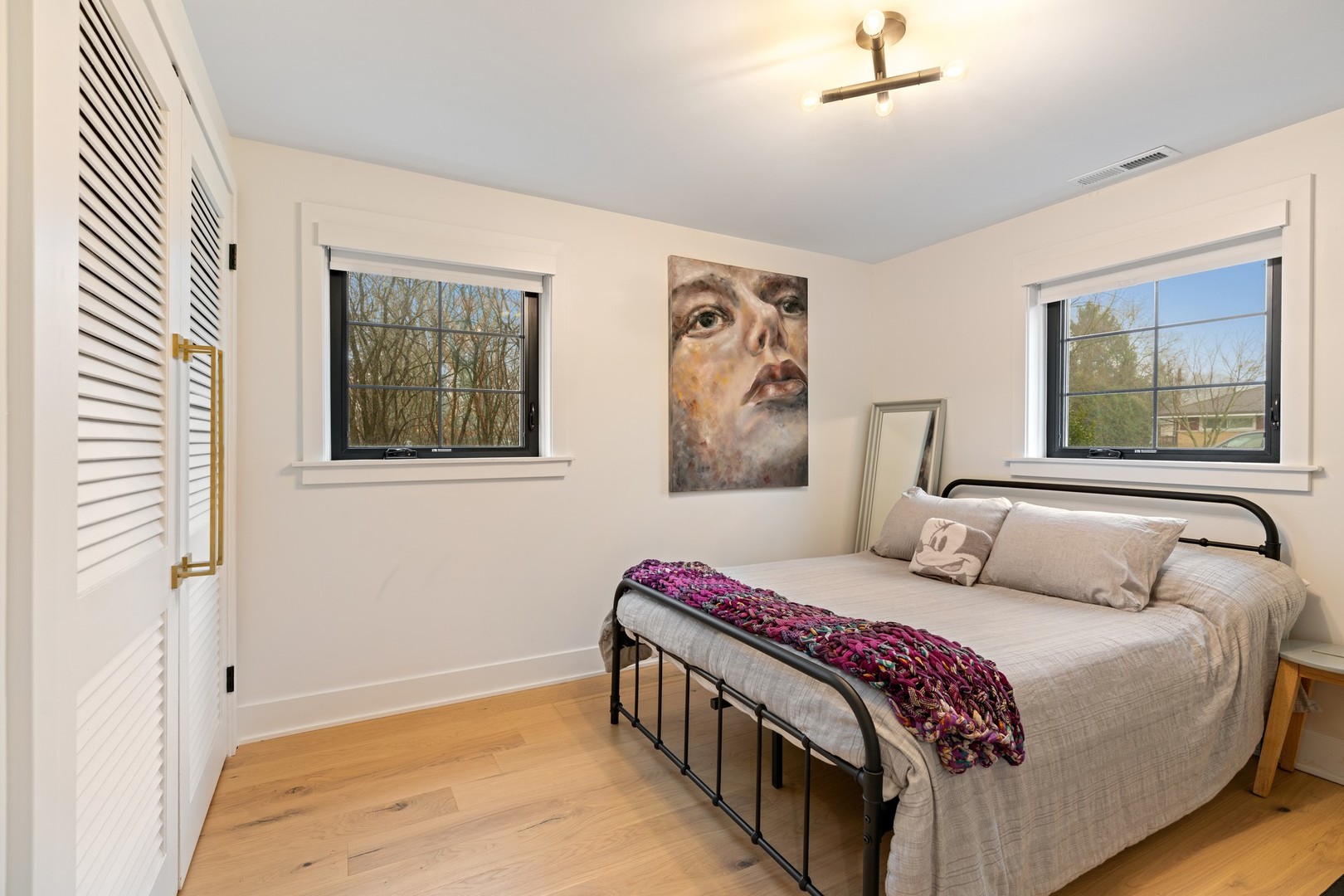 1975 Valley View Road Northfield, IL 60093 - Photo 27 of 40 a bedroom with a bed and a painting on the wall