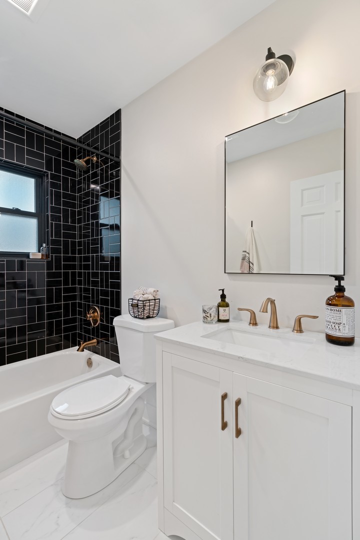 1975 Valley View Road Northfield, IL 60093 - Photo 29 of 40 a bathroom with a toilet a sink and mirror