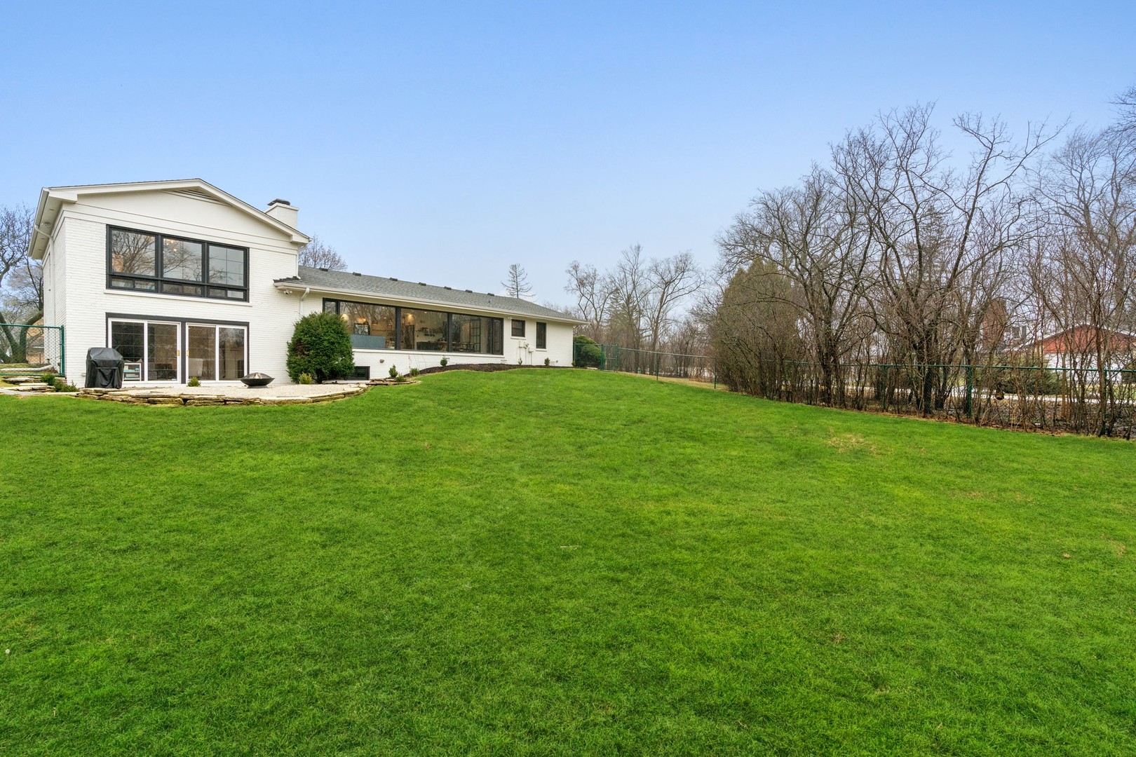 1975 Valley View Road Northfield, IL 60093 - Photo 37 of 40 a front view of a house with a garden and trees