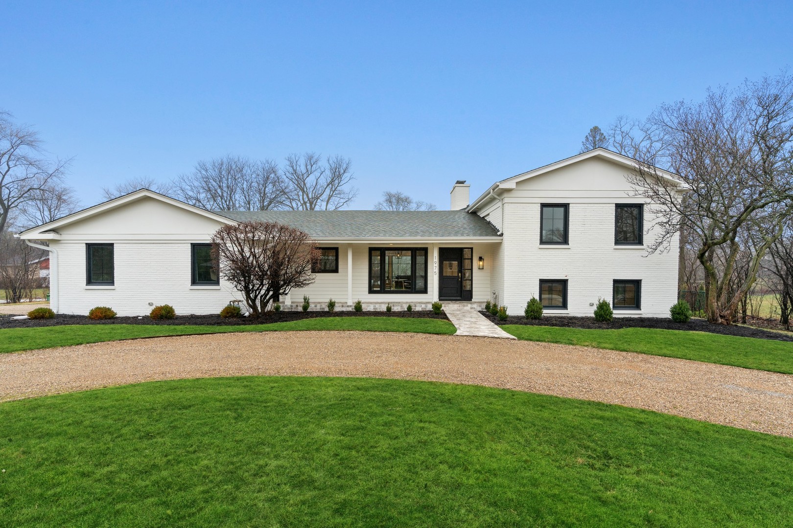 1975 Valley View Road Northfield, IL 60093 - Photo 38 of 40 a front view of a house with a yard and garage