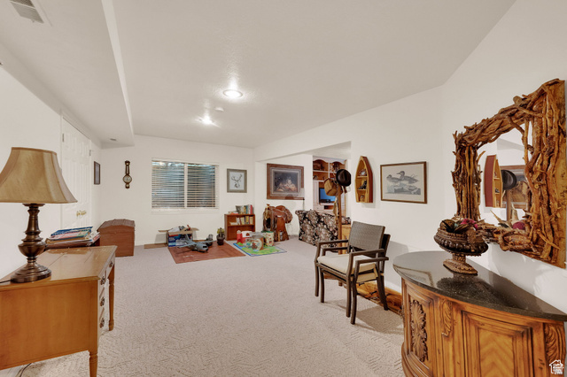 7740 Keswick Road Sandy, UT 84093 - Photo 43 of 74 Spacious room featuring carpet flooring, recessed lighting, a built-in window with horizontal blinds, and access to an additional room through an archway