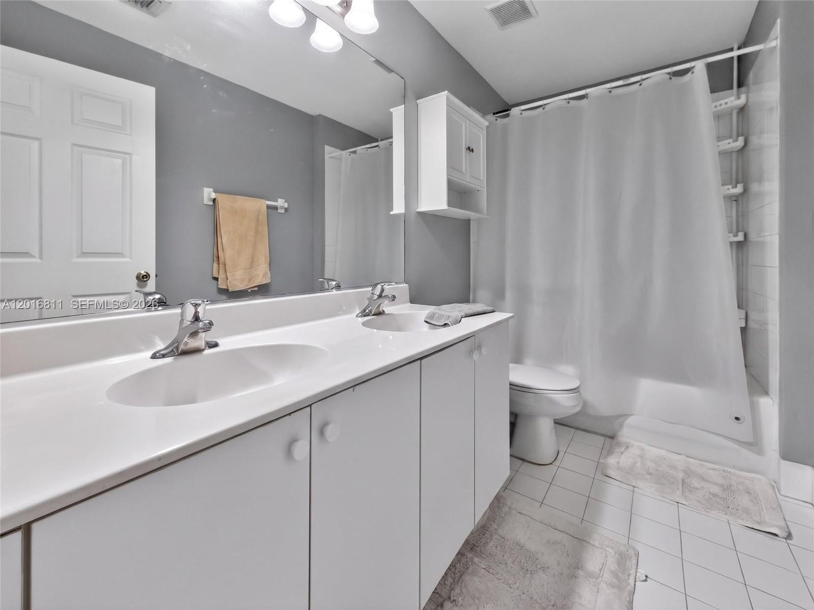 12415 Southwest 42nd Street Miramar, FL 33027 - Photo 12 of 21 a bathroom with a double vanity sink mirror and toilet