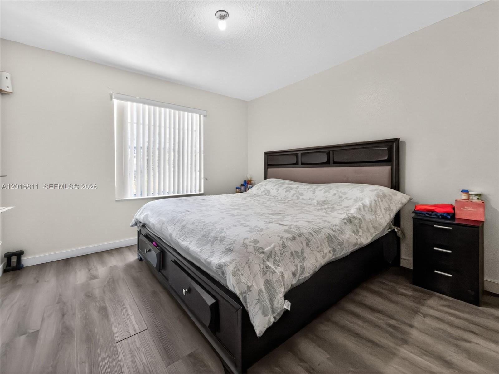 12415 Southwest 42nd Street Miramar, FL 33027 - Photo 13 of 21 a bed sitting in a bedroom next to a window
