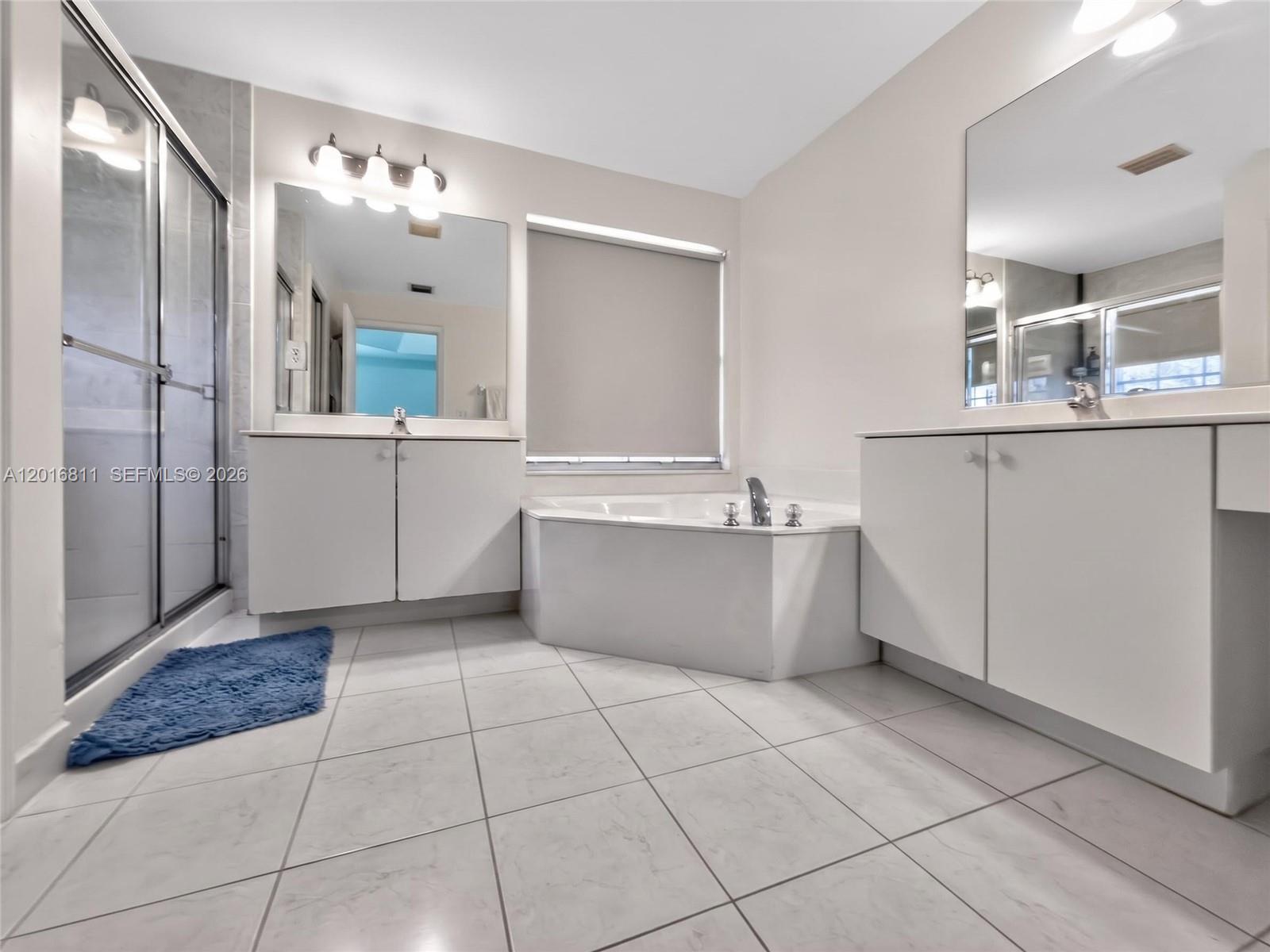 12415 Southwest 42nd Street Miramar, FL 33027 - Photo 16 of 21 a large spacious bathroom with a tub a sink and mirror