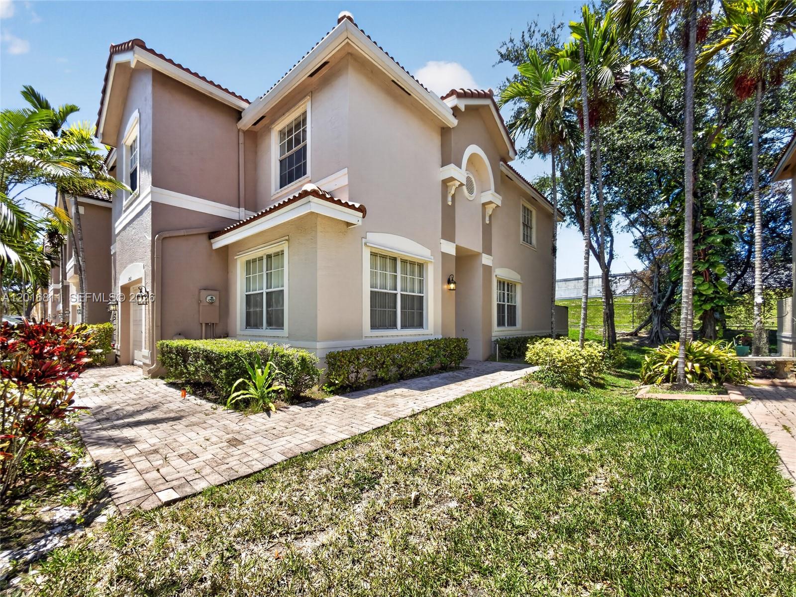12415 Southwest 42nd Street Miramar, FL 33027 - Photo 3 of 21 a front view of a house with a yard