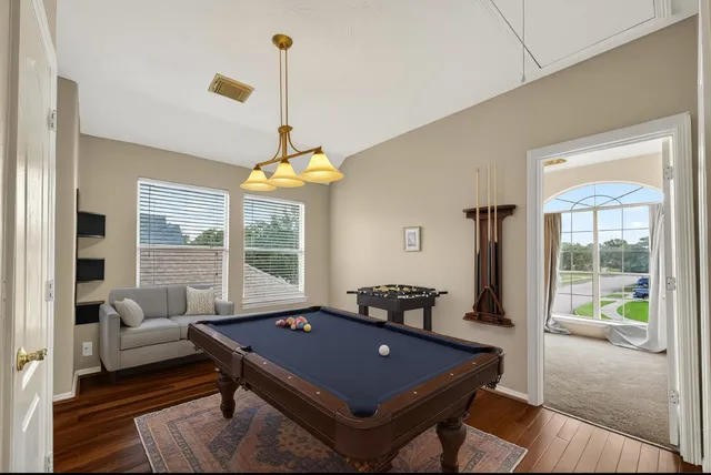an empty room with chandelier fan