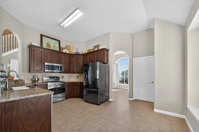 a kitchen with a sink cabinets and window