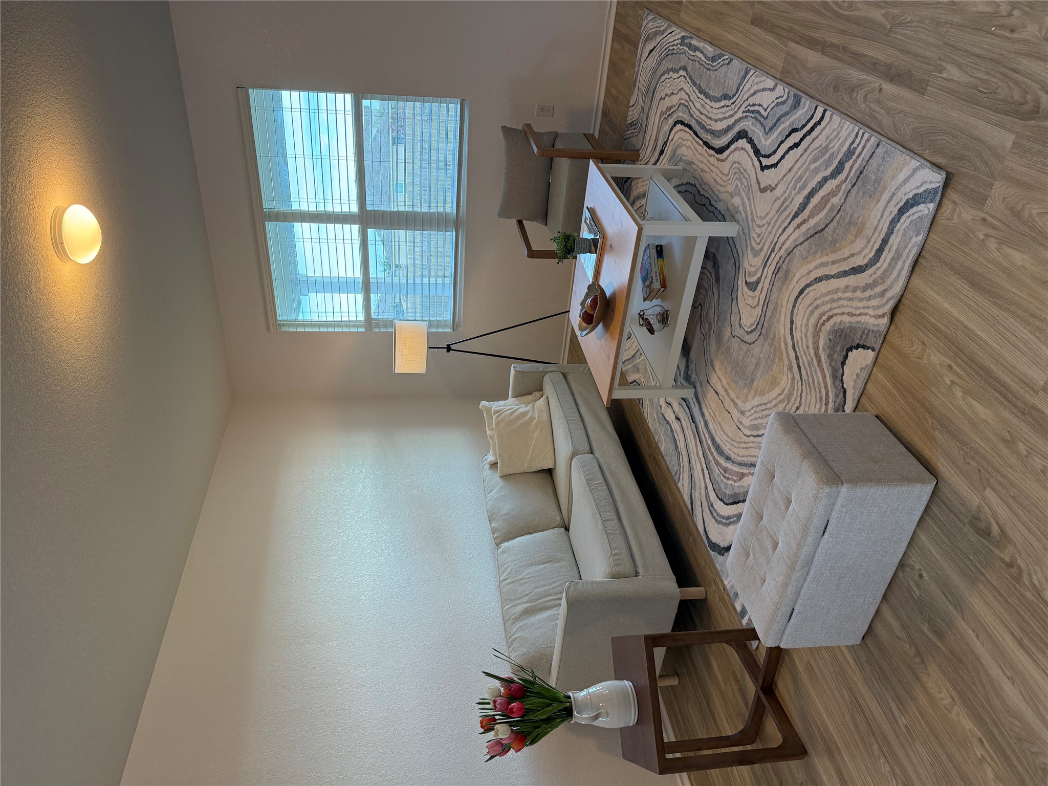 14907 Retha Pass Austin, TX 78725 - Photo 6 of 22 An inviting gathering space features warm wood flooring complemented by a stylish area rug.