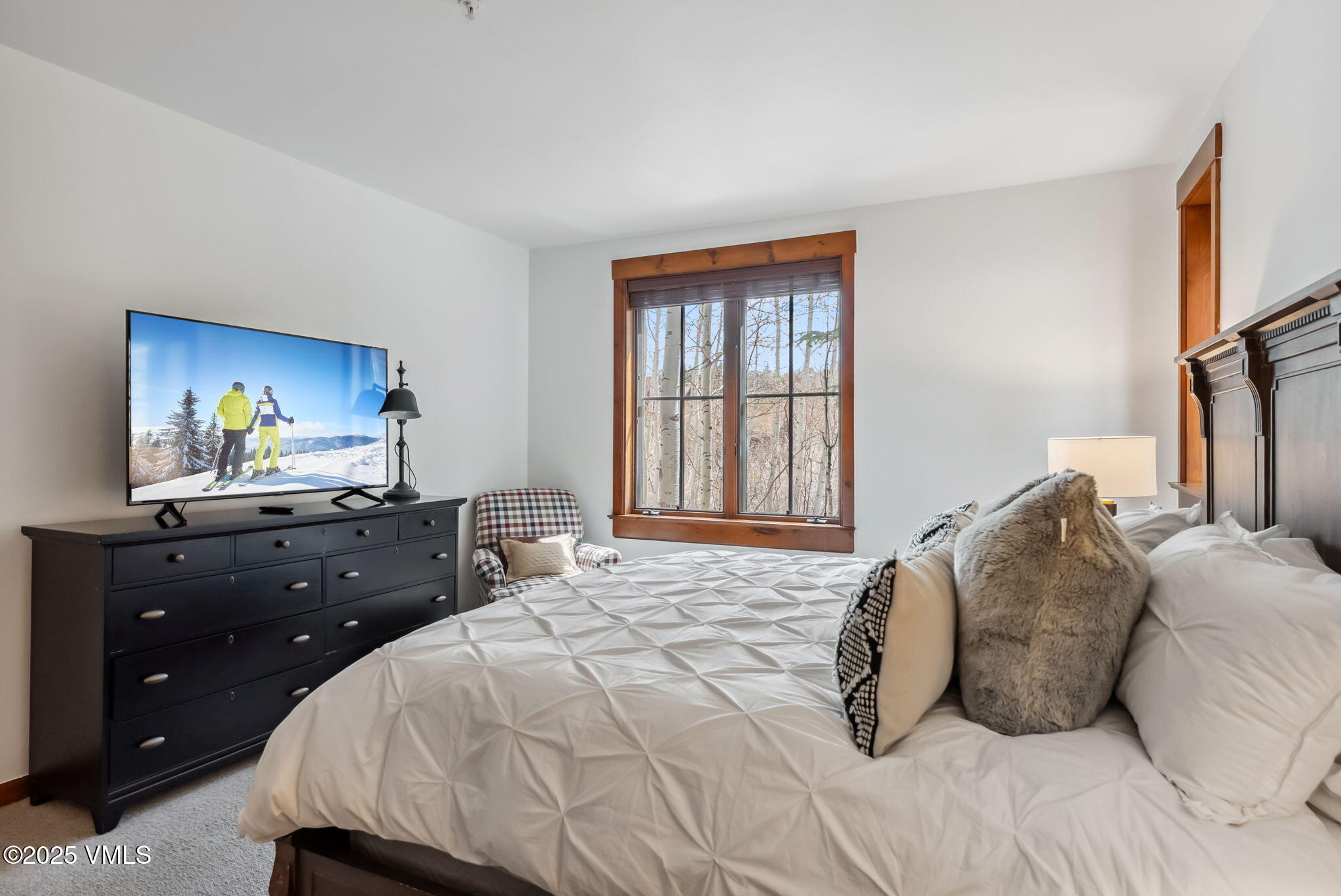 268 Bachelor Ridge Road Avon, CO 81620 - Photo 17 of 25 a bedroom with a bed and a flat tv screen on dresser