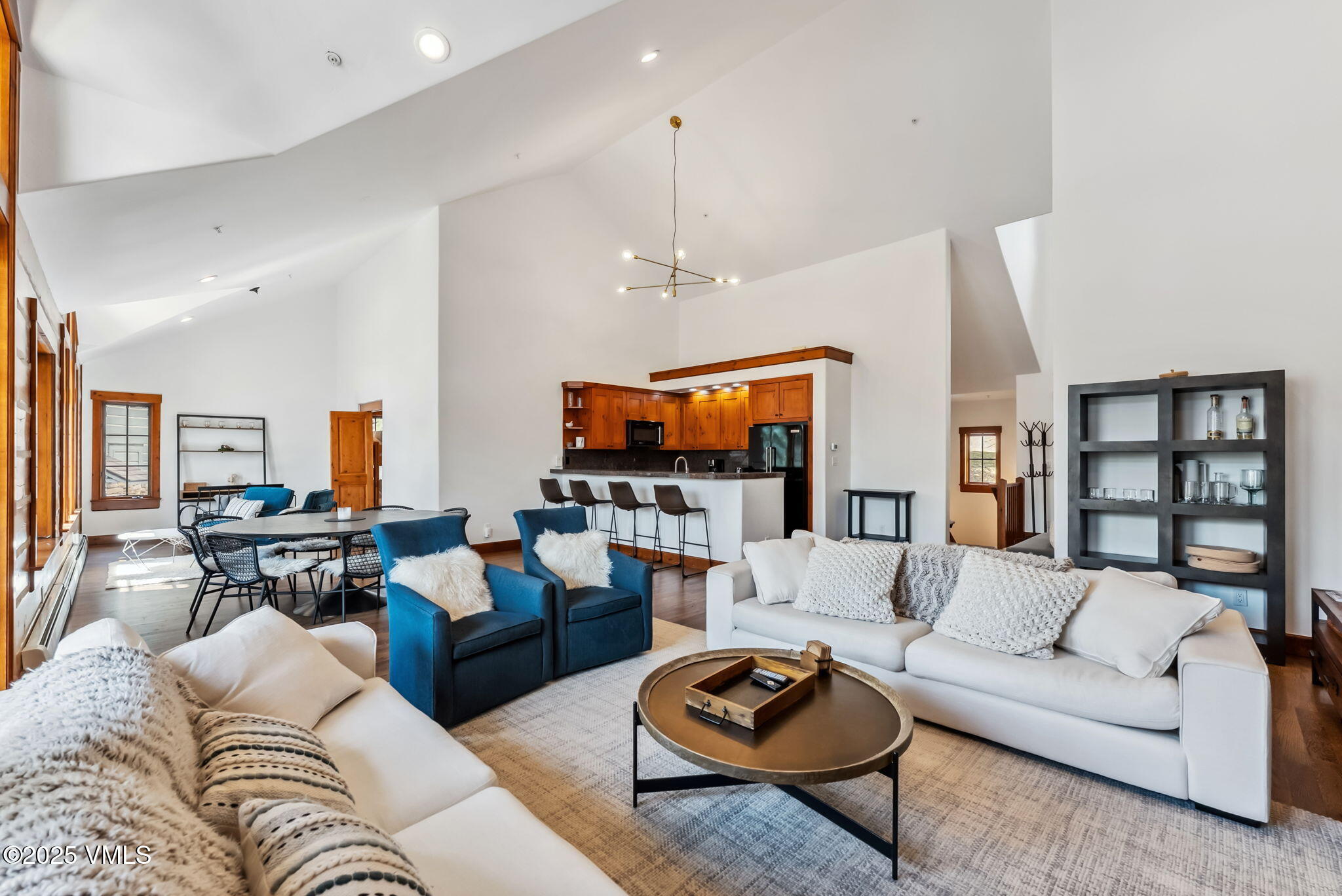 268 Bachelor Ridge Road Avon, CO 81620 - Photo 2 of 25 a living room with furniture kitchen view and a flat screen tv