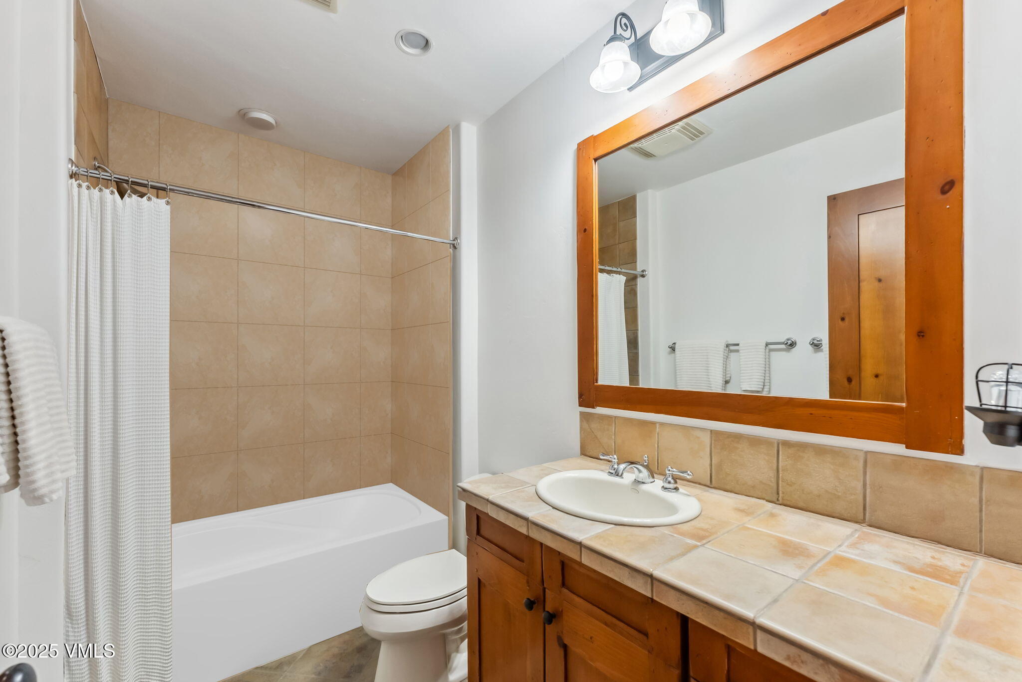 268 Bachelor Ridge Road Avon, CO 81620 - Photo 21 of 25 a bathroom with a granite countertop sink toilet and shower