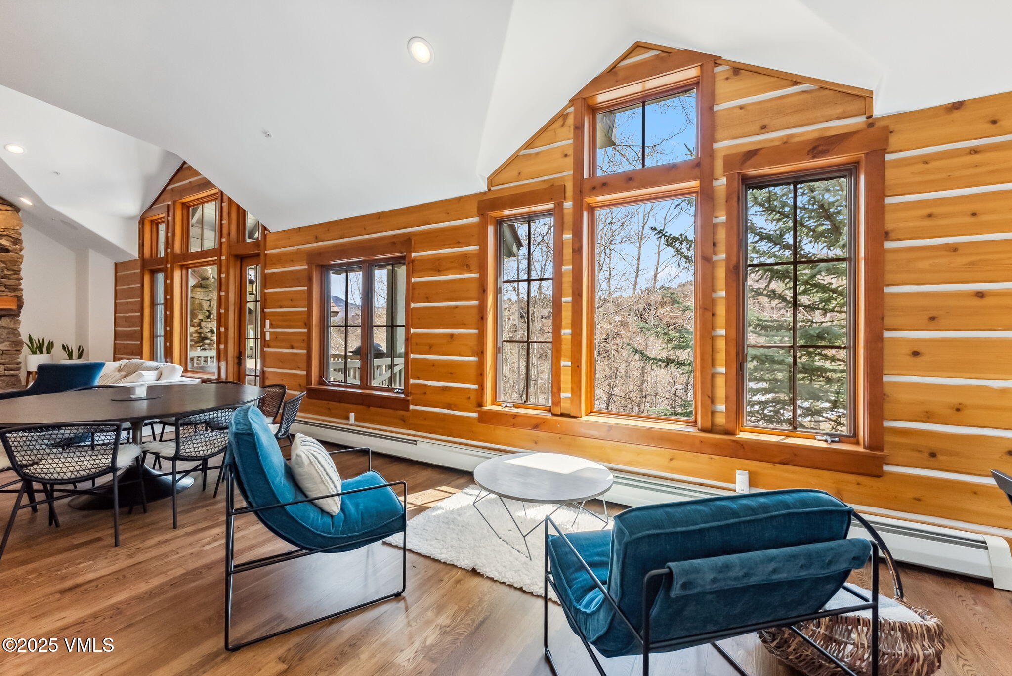 268 Bachelor Ridge Road Avon, CO 81620 - Photo 7 of 25 a living room with furniture a fireplace and large windows