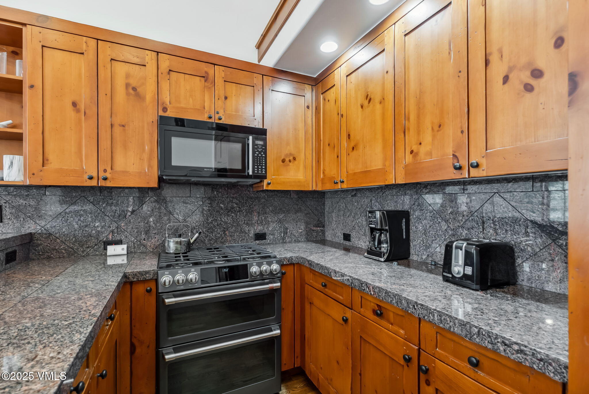 268 Bachelor Ridge Road Avon, CO 81620 - Photo 10 of 25 a kitchen with stainless steel appliances granite countertop a sink stove and microwave