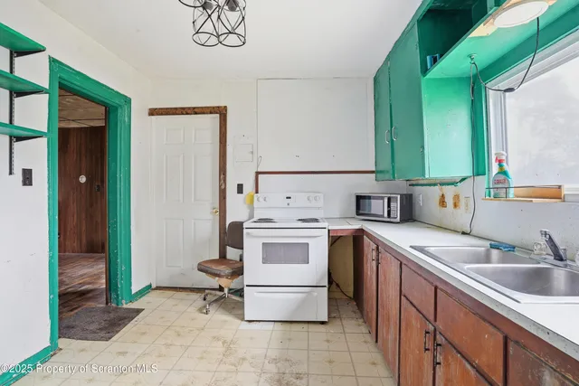 a kitchen with a sink cabinets and appliances