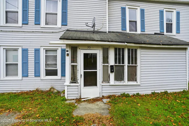 a view of a brick house with a large windows