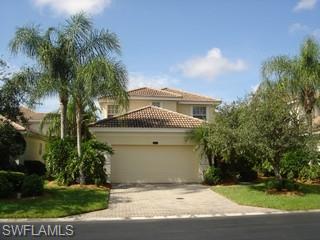 8582 Peppertree Way Naples, FL 34114 - Photo 1 of 8 a front view of a house with a garden